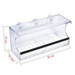 Acrylic bird feeder mounted to window with suction cups